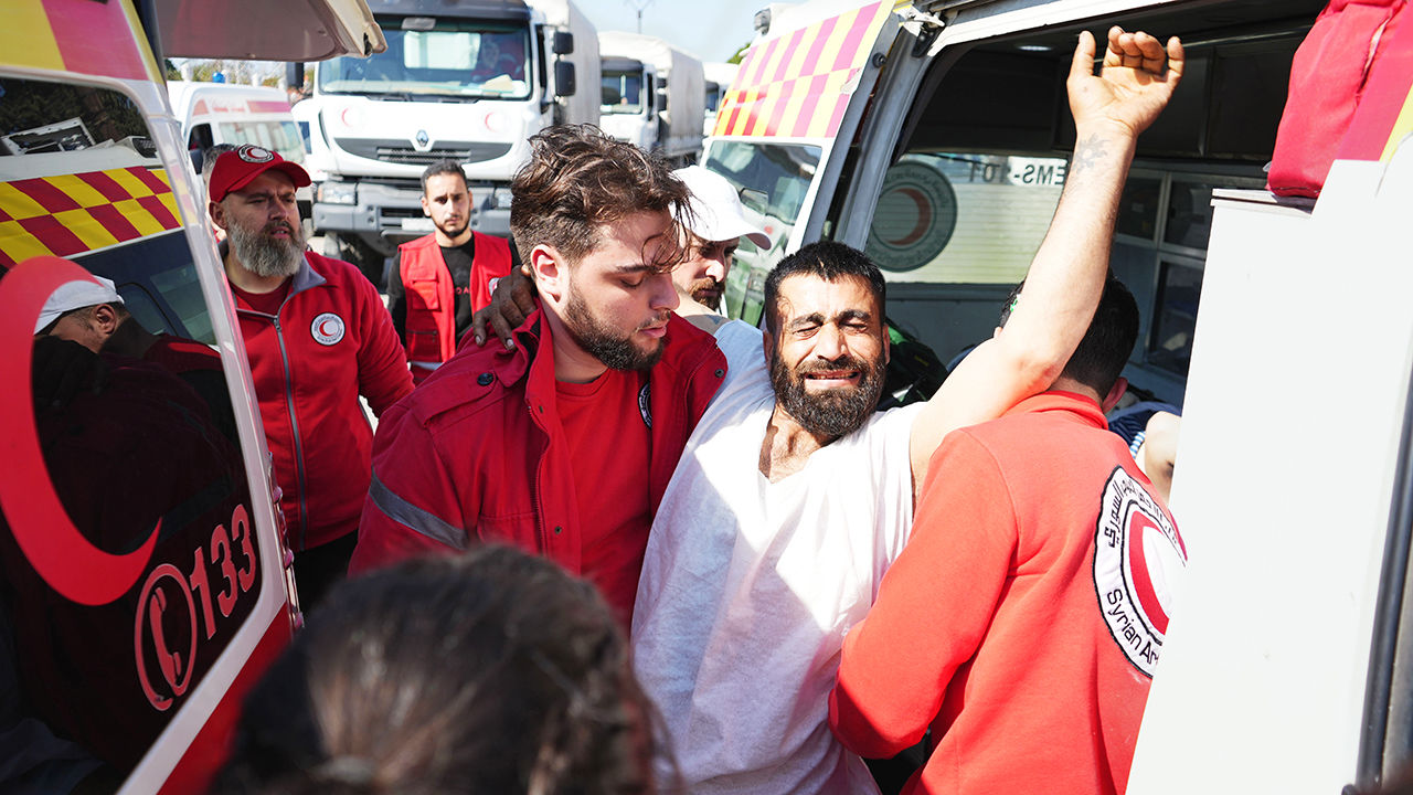 Syrian Red Crescent members transport injured civilians from the Kmeimim base, Latakia, Syria