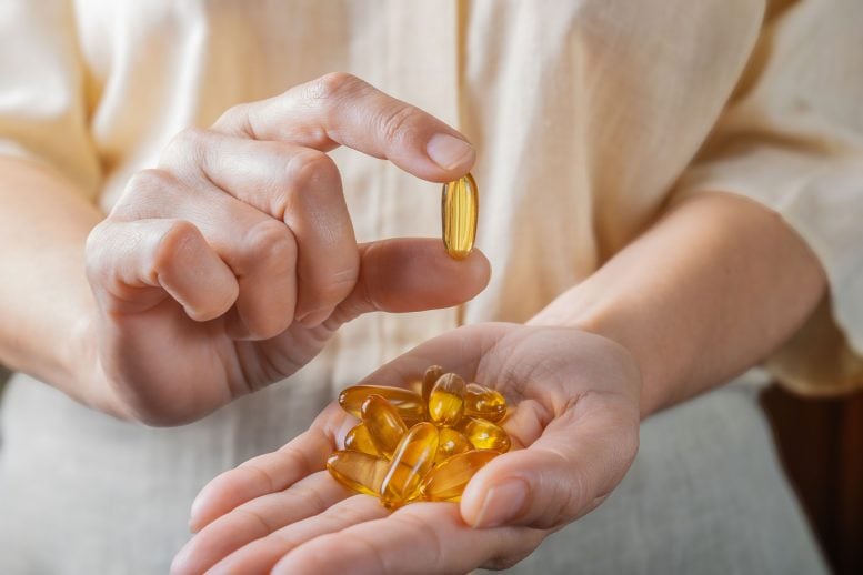 Wanita Memegang Suplemen Omega 3
