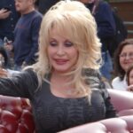 Dolly Parton rides in a parade at Dollywood.